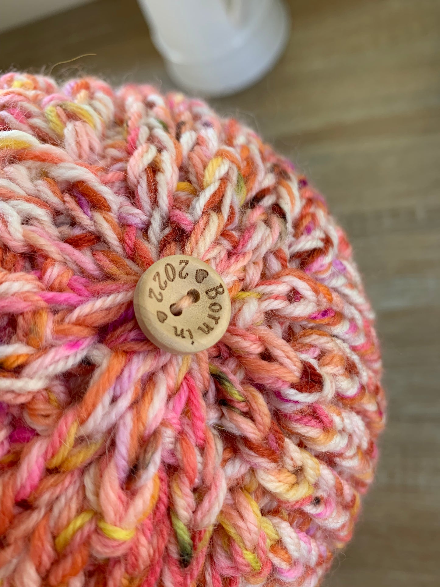 A ‘Born in 2022’ Toddler to Teen knit hat - pink/cream/yellow/peach marled
